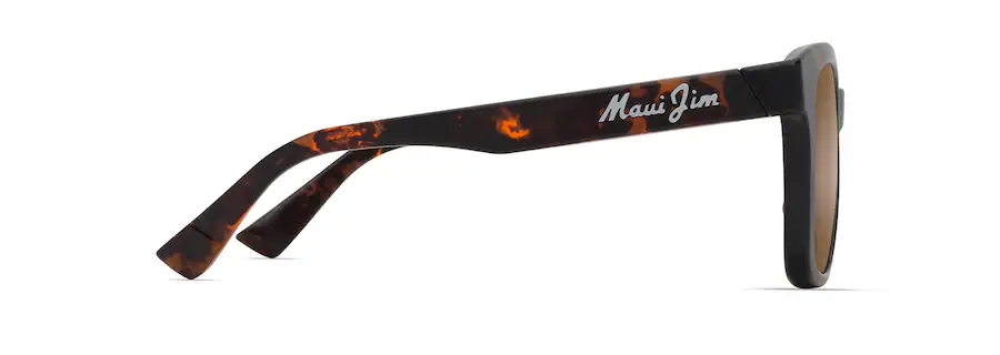 Side view of tortoiseshell Maui Jim sunglasses with brown lenses and the brand name written in white on the arm, showcasing an auto-drafted design.