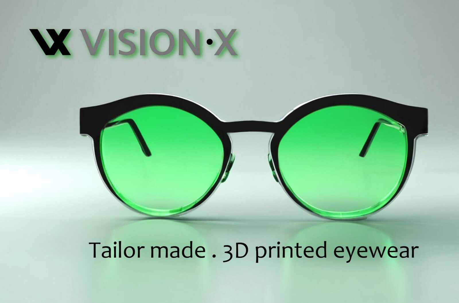 A pair of green-lensed eyeglasses is displayed with the text "VISION·X Auto Draft" in the top-left corner. The bottom text reads "Tailor made. 3D printed eyewear.